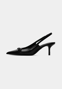 Sandal de salto kitten preto, com biqueira pontiaguda e slingback, possuindo uma pequena fivela decorativa na parte da frente e acabamento em couro liso.