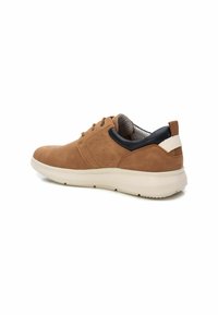 Zapatillas de ante marrón con suela de goma blanca, que presentan un cuello de malla azul marino y detalles perforados en los laterales para mayor transpirabilidad.