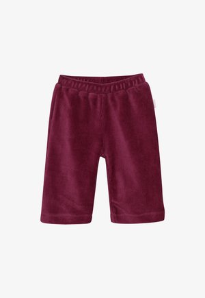 Pantalons pour bébé en velours côtelé maroon doux avec une taille élastique et une petite étiquette sur le côté, présentés sur un fond blanc.