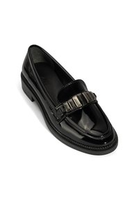 Black patent leather loafer with a low heel and a decorative metallic chain detail across the upper.