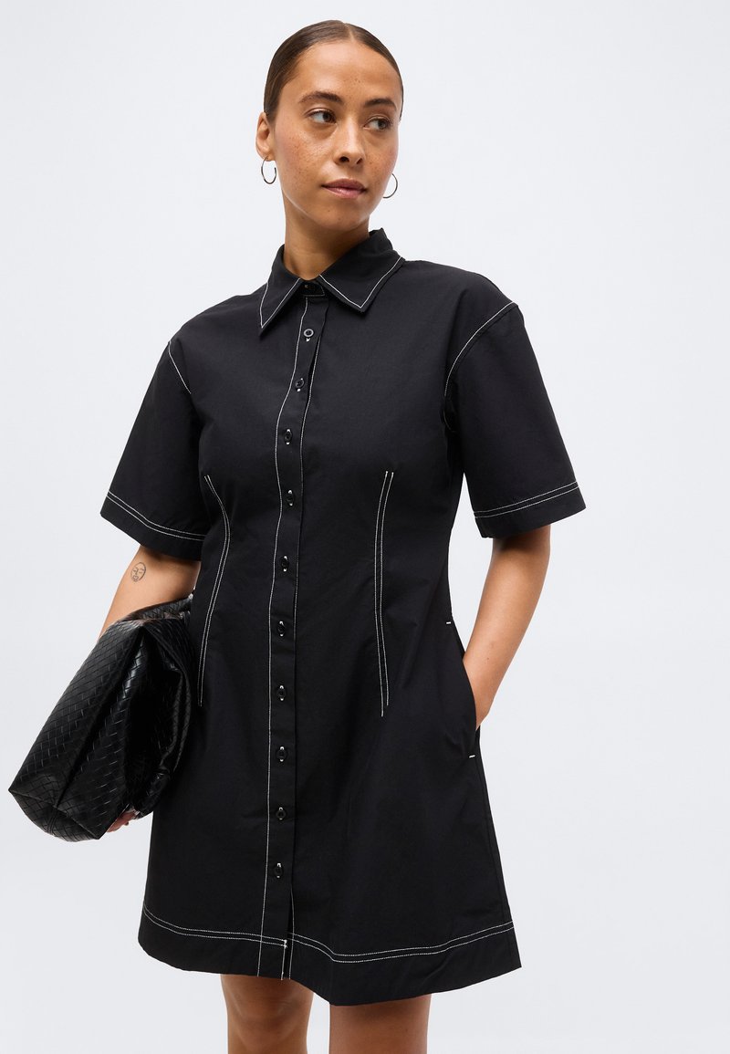 black shirt dress with white stitching Black Collared Shirt Dress with Scalloped Edges and White Piping Contr To The Nines