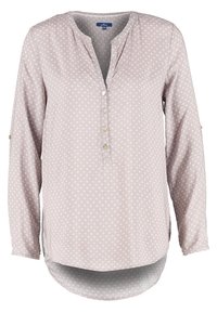 Blouse mauve clair à manches longues avec petit motif floral blanc, encolure ronde, patte de boutonnage et ourlet légèrement incurvé.