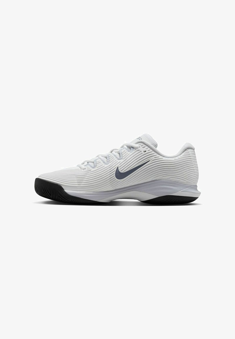 Witte Nike lage sportschoen met een textuur bovenkant, zwarte zool en donkergrijze swoosh-logo aan de zijkant.