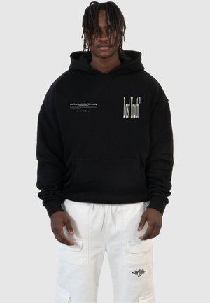 Black hoodie with front pocket, featuring white text "Lost Youth" and "youth is wasted on the young" in a modern font. Soft fabric texture.