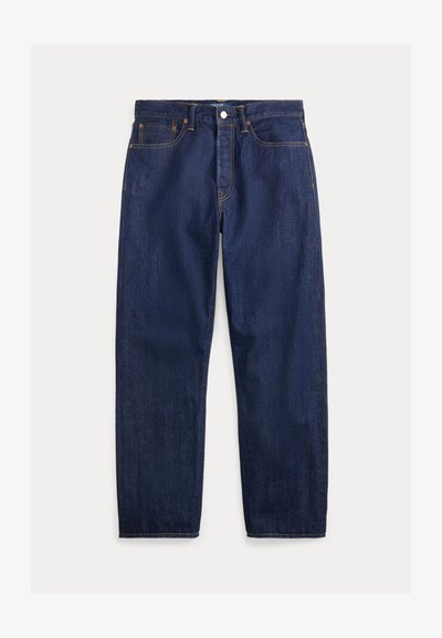 Tumši zila džinsu auduma bikses ar taisno kāju dizainu, ar rāvējslēdzēju, divām priekšējām kabatām un redzamām oranžām šuvēm.