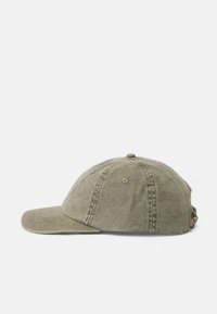 Boné de beisebol verde-azeitona feito de algodão, com aba curva, design de seis painéis e orifícios de ventilação, apresentando uma faixa de tecido para ajuste.