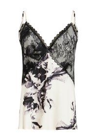 Caraco en soie avec imprimé floral noir sur tissu blanc, avec un empiècement en dentelle noire sur la poitrine et des fines bretelles réglables.