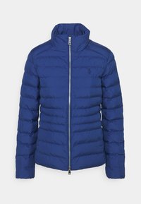 Tummansininen puhvijakku, jossa on tikattu muotoilu, korkea kaulus, täysi vetoketju ja hillitty logo. Ominaisuuksiin kuuluu tyylikäs, sileä pinta.