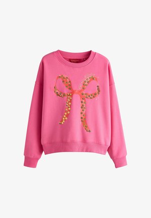 Rosa Sweatshirt mit einer großen Schleifen-Grafik, verziert mit metallisch goldenen und schwarzen runden Pailletten. Weit geschnitten mit lässiger Passform und gerippten Bündchen.