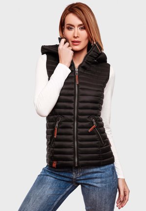 Black padded vest with a hood, zippered front, two side pockets, and contrasting orange hardware details. Worn over a white long-sleeve shirt.