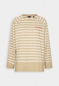 Beige-weiße gestreifte langärmelige T-Shirt mit Rundhalsausschnitt und rotem "GANT"-Logo auf der Brust. Hergestellt aus weichem Baumwollmaterial.