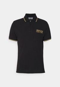 Svart polo skjorta i bomull med tvåknappsslutning, gula detaljer på kragen och ärmarna, med en broderad "VERSACE JEANS COUTURE" logga.