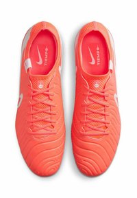 Nike Tiempo voetbalschoenen in fel koraal met getextureerde rubberen zolen, witte accenten en veters. Voorzien van een mesh-tong en gewatteerde kraag.