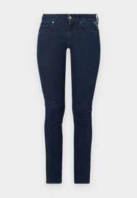 Jeans skinny de mezclilla azul oscuro con cintura alta, cinco bolsillos y cierre de botón en la parte delantera. Textura suave con un leve estiramiento.