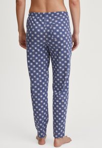 Blauwe pyjamabroek met een zonnestraalpatroon, elastische tailleband en achterzak, gemaakt van een gladde, lichte stof.