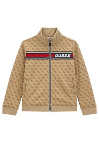Veste beige zippée avec motif logo ton sur ton, col montant, bande horizontale noire et rouge avec le texte 'GUESS' sur la poitrine, poches latérales.