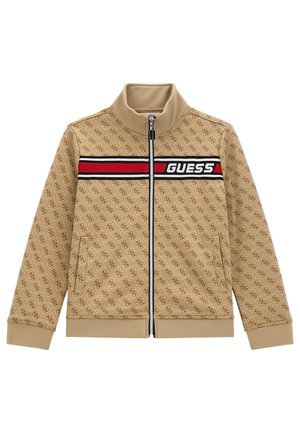 Veste beige zippée avec motif logo ton sur ton, col montant, bande horizontale noire et rouge avec le texte 'GUESS' sur la poitrine, poches latérales.