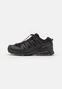 Black athletic shoes with a breathable mesh upper, rubber outsole, and quick-lace system. Features reinforced toe and textured accents.