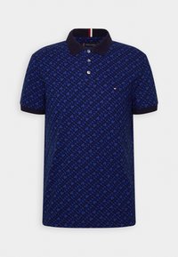 Polo bleu marine avec un motif géométrique, manches courtes et col contrastant. Comprend une patte de boutonnage à trois boutons et un petit logo.