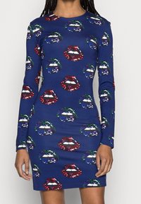 Navy blue long-sleeve dress patterned with large colorful lips decorated with floral designs in red, green, purple, and blue tones.