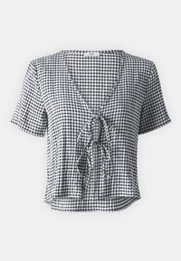 Blouse à manches courtes en vichy noir et blanc, présentant un col en V et un design à nouer sur le devant. Confectionnée en tissu léger avec une coupe décontractée.