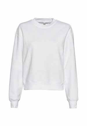 Balta sporta krekla ar apaļu kakla izgriezumu, garām piedurknēm un ribotiem suknīšu galiem. Tam piemīt brīvs piegriezums un mīksta, teksturēta auduma virsma.