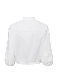Weiße Bluse mit gestickten Blumenmotiven an den Ballonärmeln und einem gerafften Saum. Leichter, strukturierter Stoff mit weichem Finish.