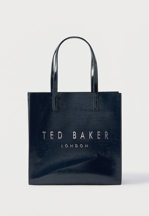 Tumesinist nahast käekott läikiva viimistlusega, mille esiküljel on reljeefse metallkirjaga "TED BAKER LONDON". Kahel käepidemel.
