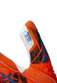 Orange sports glove featuring a textured grip, black and blue geometric patterns, reinforced padding, and a white label with "solid" branding.