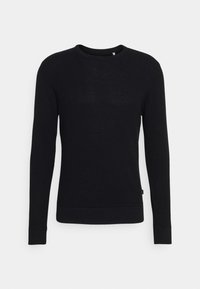 Suéter negro de mangas largas con un diseño de tejido texturizado. Presenta un cuello redondo y puños y dobladillo acanalados. Estilo simple y minimalista.