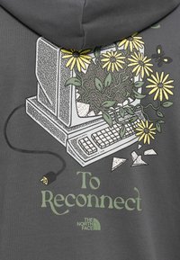 Gray sweatshirt featuring a graphic of a vintage computer adorned with yellow flowers, green leaves, and the text "To Reconnect."