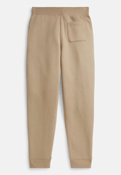 Beige Jogginghose aus weichem Stoff, mit schmal zulaufendem Bein, elastischem Bund und einer einzelnen aufgesetzten Gesäßtasche.