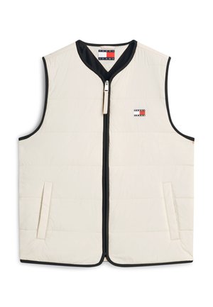 Μπεζ αμάνικο φουσκωτό γιλέκο με μαύρο περίγραμμα, μπροστινό φερμουάρ, πλαϊνές τσέπες και μικρό λογότυπο Tommy Jeans στο στήθος.