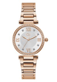 Rózsa arany színű óra kerek tokjával, ezüst színű számlappal, római számokkal és kristály díszítéssel. Fém link bracelet fényes felülettel.