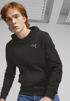 Black hoodie with a kangaroo pocket, featuring a white embroidered logo on the chest. Fabric appears smooth, with a relaxed fit.
