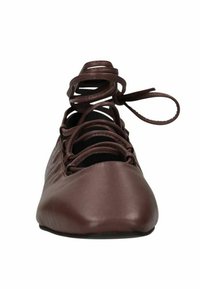 Bruine leren balletschoen met een spitse neus en een kruis- en vetersluiting. Gladde textuur, minimale details, flexibele zool.