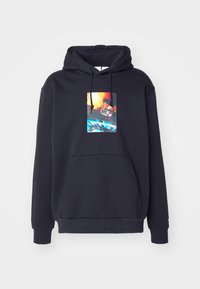 Black hoodie with front pouch pocket and abstract colorful graphic of a person holding objects printed in the center chest area.