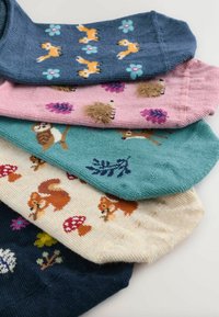Colorful socks stacked in layers featuring various animal designs. Materials are textured cotton, with patterns of foxes, mushrooms, and flowers.