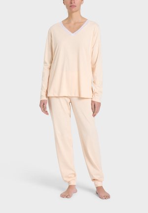 Set di abbigliamento per il tempo libero in pesca chiaro, composto da una maglietta a maniche lunghe con scollatura a V e pantaloni abbinati con polsini aderenti, realizzato in tessuto morbido e liscio.