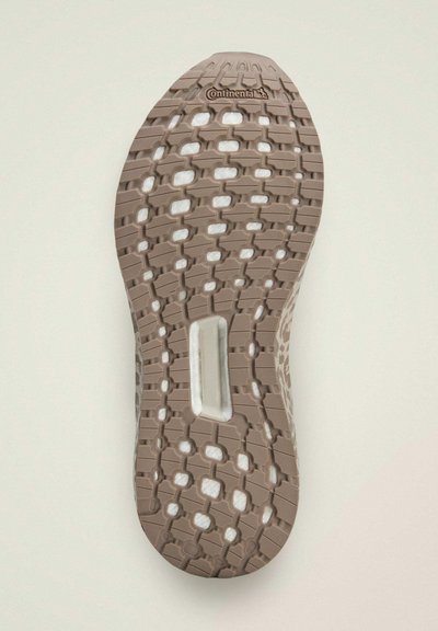 Beige rubber shoe sole with patterned texture, featuring a white midsole and the "Continental" logo embossed on the surface.