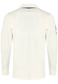 Langærmet polo skjorte i cremefarvet bomuld, med krave og ribbede manchetter. Broderet design på venstre ærme.