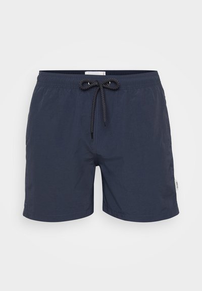 Mørkeblå svømmebukser laget av lett stoff, med elastisk midje og snor samt sidelommer. Enkel design, uten mønstre.
