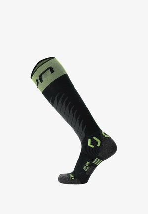 Black and green knee-length sock with textured pattern; reinforced heel and toe, featuring logo accents and cushioning zones for comfort.