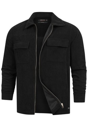 Giacca camicia in cotone a coste nera con colletto a punte, chiusura con zip frontale, due tasche sul petto e texture a coste.