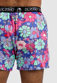 Colorful boxer shorts featuring a floral pattern with pink, green, and blue flowers, black waistband with the text "LOUSY," made of lightweight fabric.