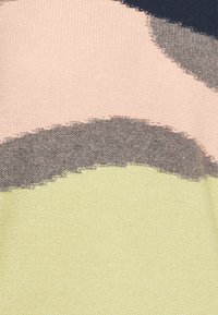 Motif abstrait en tissu tricoté avec des blocs ressemblant à des coups de pinceau dans des couleurs rose pâle, gris, bleu marine et jaune clair.