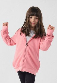 Felpa con cappuccio rosa con zip, texture liscia, vestibilità oversize e maniche lunghe. Presenta una zip frontale e dettagli a coste su polsini e orlo.