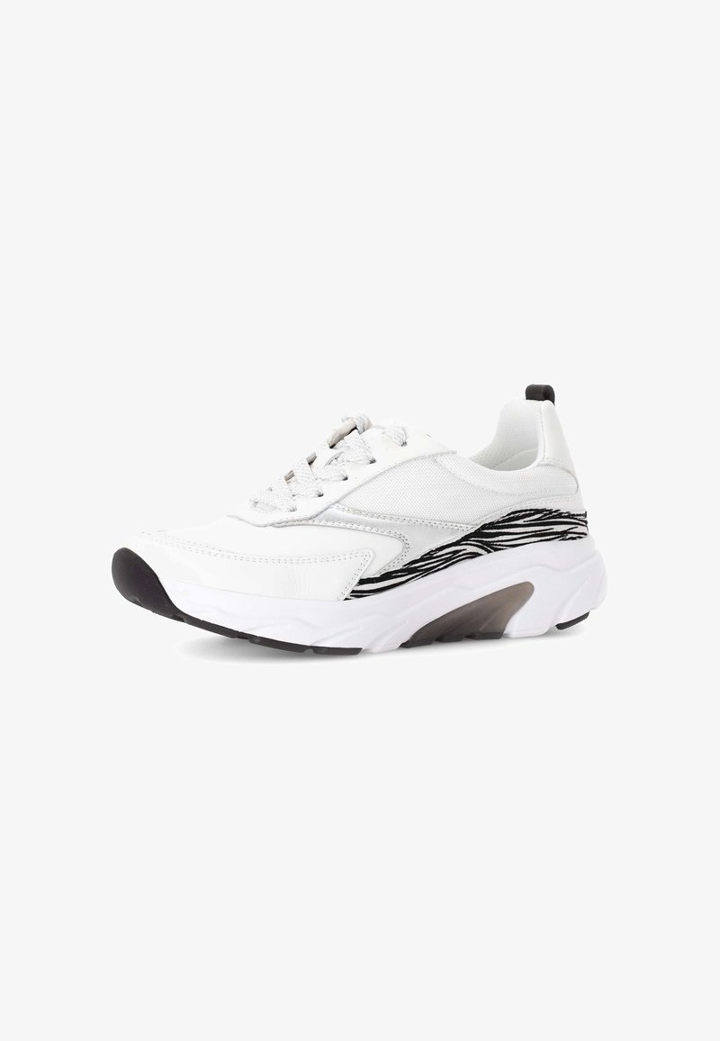 White sneaker featuring a smooth leather upper, mesh details, a black wave pattern on the side, and a textured rubber sole with a slight heel.