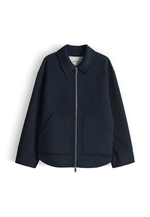 Marineblauer Jacke aus Wollmischung mit Kragen, Frontreißverschluss und zwei großen Taschen. Verfügt über eine lockere Passform und eine strukturierte Stoffoberfläche.