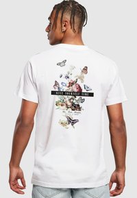 White cotton t-shirt featuring a floral and butterfly graphic on the back with the text "GIVE YOURSELF TIME" prominently displayed.